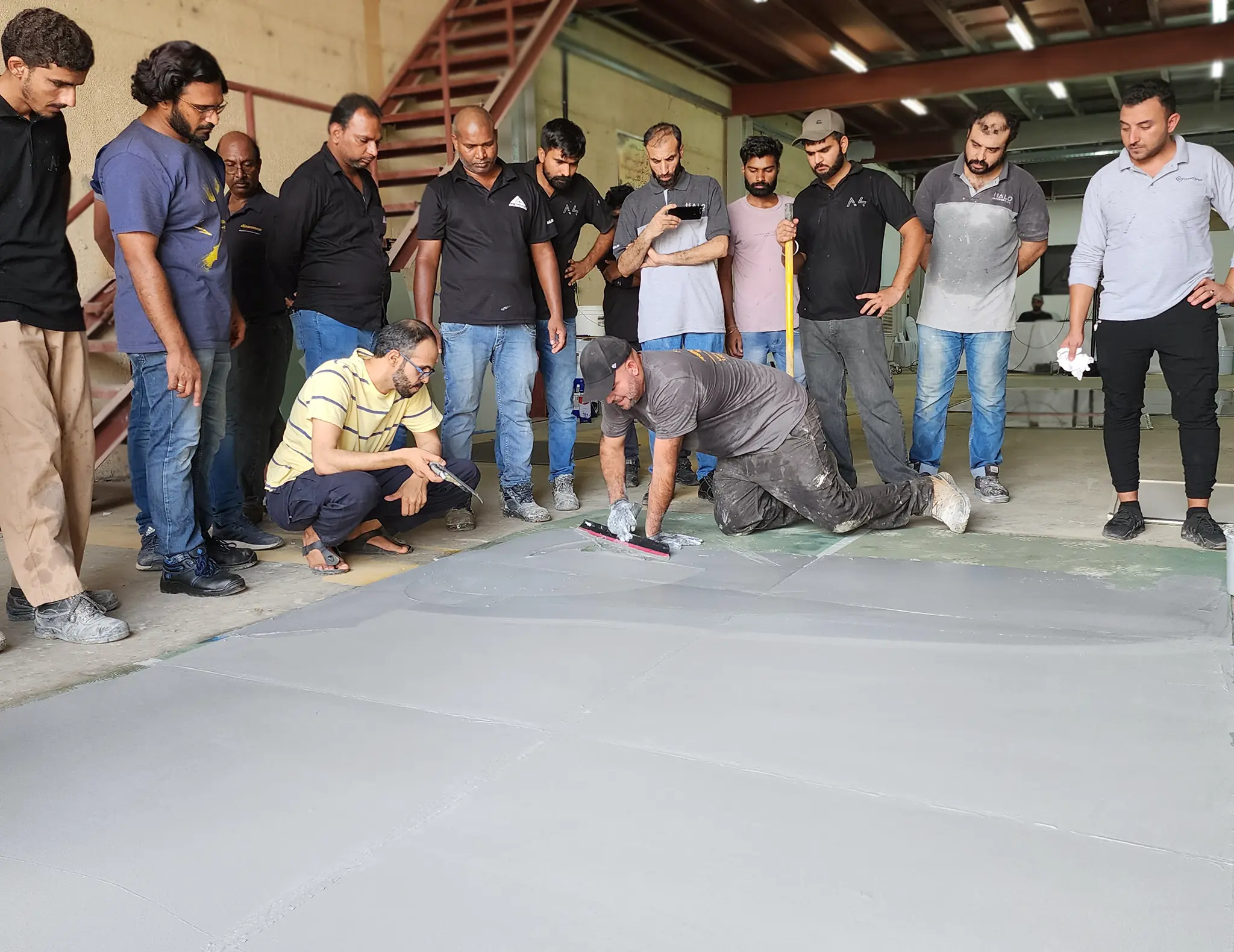 An instructor teaches concrete flooring overlay techniques at an InstallersEdge workshop in Dubai, UAE
